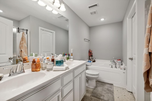 full bathroom featuring a garden tub, double vanity, visible vents, and a sink