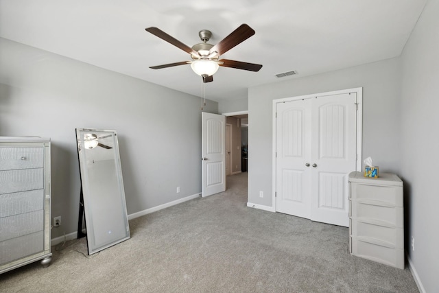 unfurnished bedroom with visible vents, baseboards, carpet, and a closet