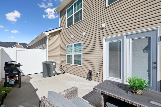 view of patio featuring fence and central AC