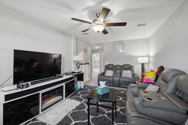 carpeted living area with a ceiling fan and visible vents