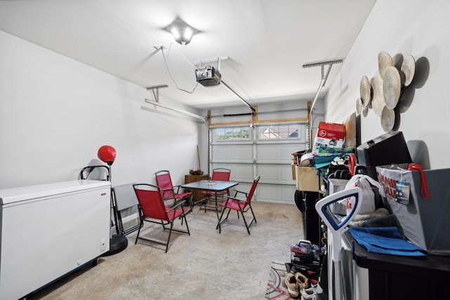 garage featuring fridge and a garage door opener