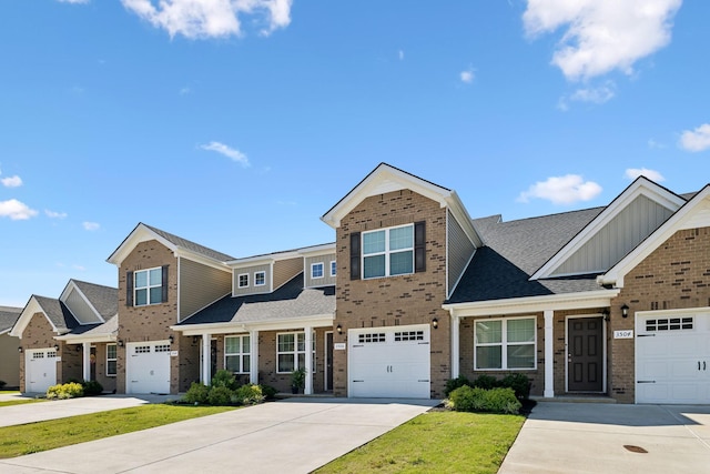 view of front of home with a garage, brick siding, and driveway