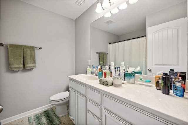 bathroom featuring visible vents, baseboards, toilet, and vanity