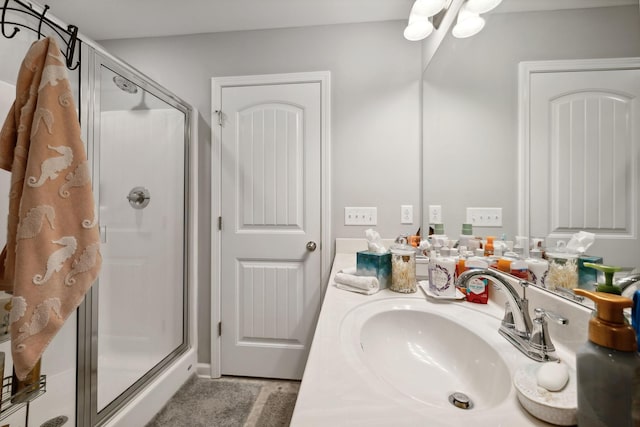 bathroom featuring a stall shower and vanity