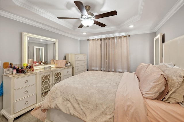 bedroom with light carpet, a ceiling fan, a tray ceiling, recessed lighting, and crown molding