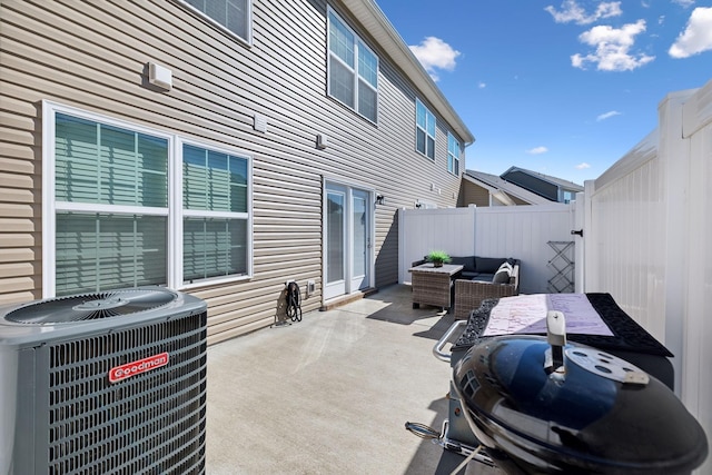 view of patio / terrace with an outdoor living space, central AC unit, and a fenced backyard