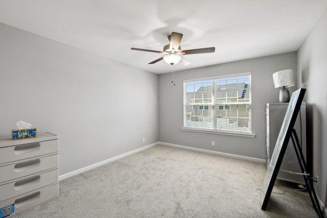 unfurnished bedroom with ceiling fan, baseboards, and carpet floors