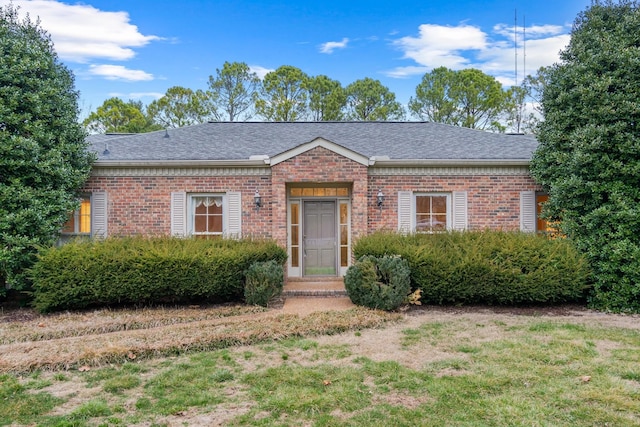 single story home with brick siding and a shingled roof