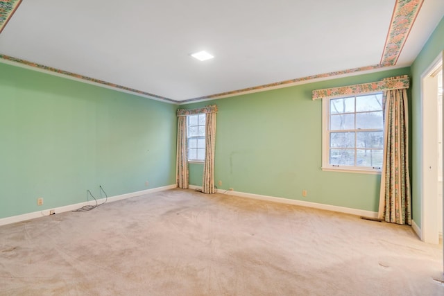 carpeted spare room with baseboards and ornamental molding