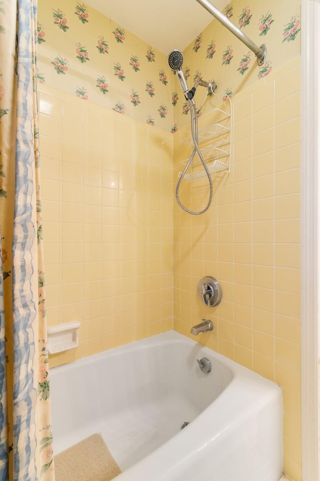 full bath featuring shower / tub combo with curtain and wallpapered walls