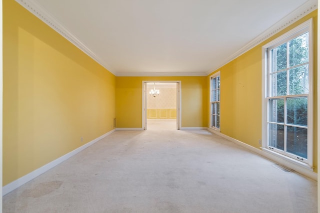 carpeted empty room featuring visible vents, an inviting chandelier, crown molding, and baseboards