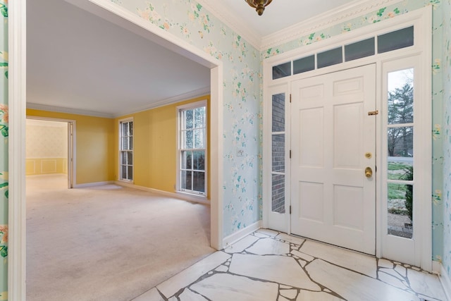 entrance foyer featuring carpet flooring, wallpapered walls, and ornamental molding