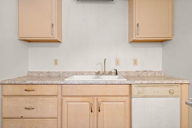 kitchen featuring dishwasher, light countertops, light brown cabinets, and a sink