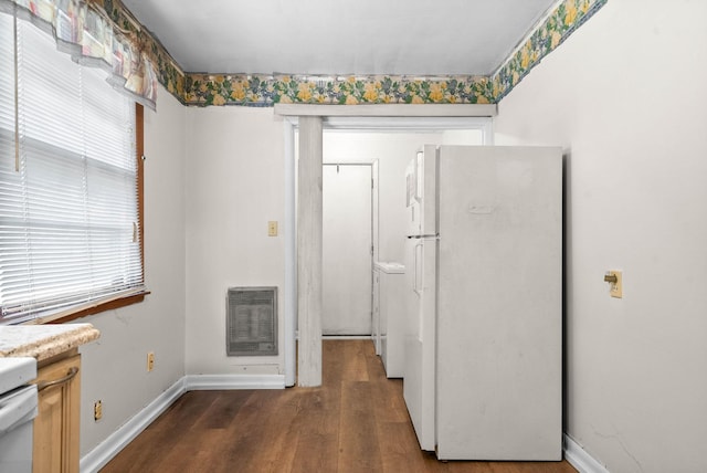 kitchen with light countertops, wood finished floors, baseboards, and freestanding refrigerator