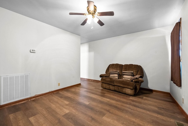 sitting room featuring wood finished floors, visible vents, and baseboards