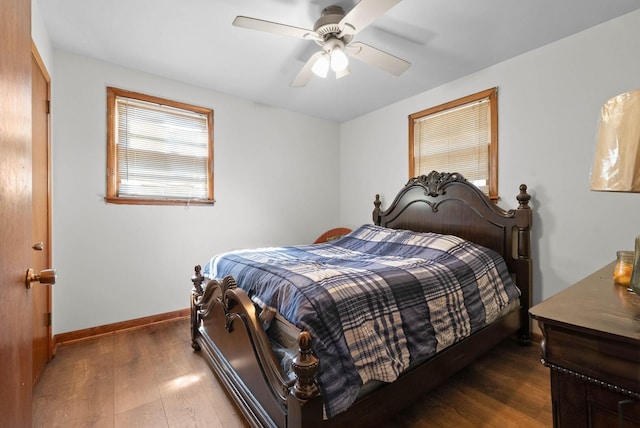 bedroom with dark wood finished floors, ceiling fan, and baseboards