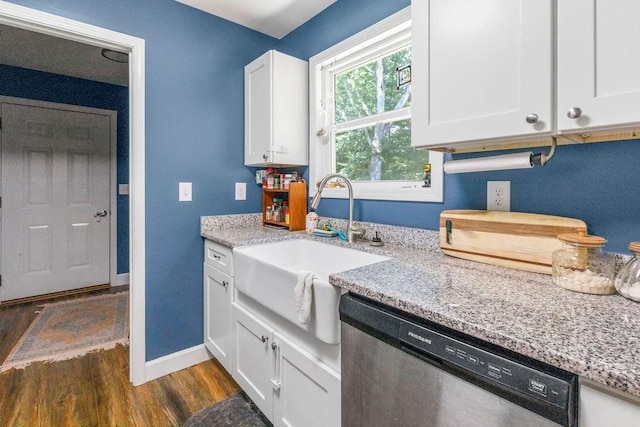 kitchen with dark wood-type flooring, a sink, stainless steel dishwasher, white cabinets, and light stone countertops