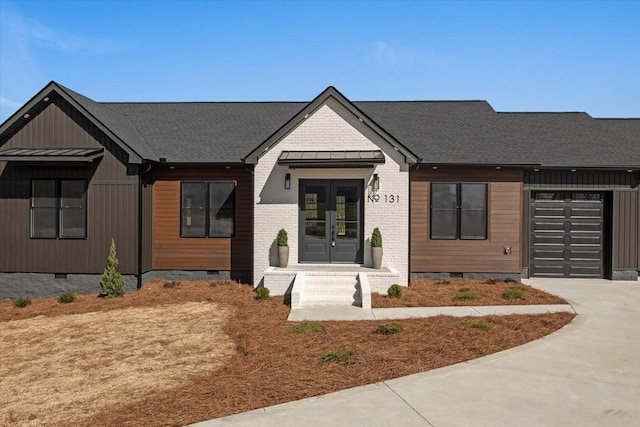 view of front of house with a standing seam roof, french doors, metal roof, an attached garage, and crawl space