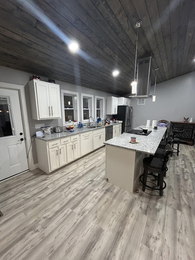 kitchen with white cabinets, stainless steel refrigerator with ice dispenser, dishwasher, wall chimney exhaust hood, and light wood-type flooring