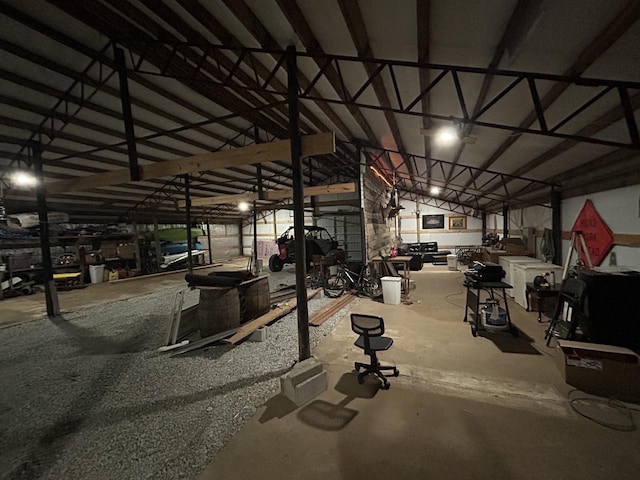 miscellaneous room featuring vaulted ceiling and unfinished concrete floors