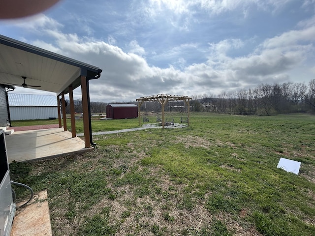 180 Schultz Ln, Huntland, TN 37345 - view of yard featuring an outbuilding, a patio area, a pergola, and a storage shed