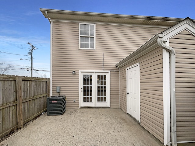 rear view of house featuring cooling unit, fence, and a patio area