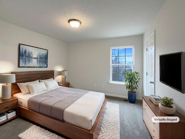 bedroom with baseboards and carpet floors