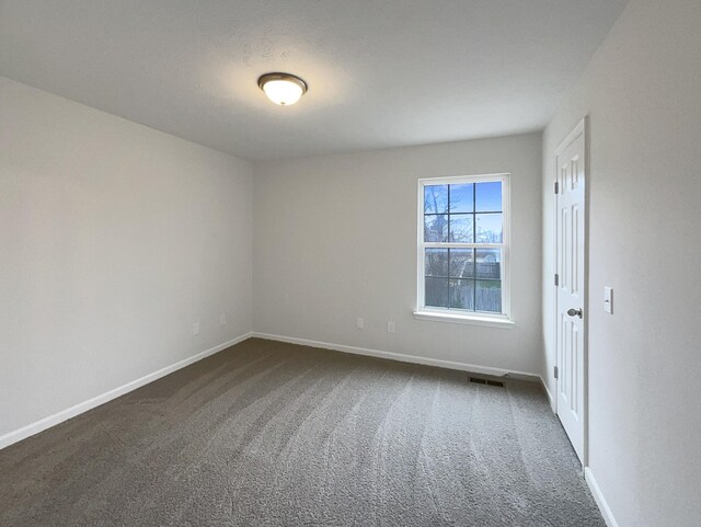 9004 Nathanael Dr, La Vergne, TN 37086 - spare room featuring dark colored carpet and baseboards