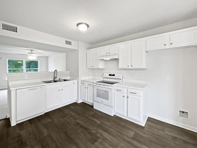 9004 Nathanael Dr, La Vergne, TN 37086 - kitchen featuring white appliances, a sink, under cabinet range hood, a peninsula, and dark wood finished floors