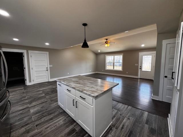 kitchen with decorative light fixtures, dark wood finished floors, white cabinetry, recessed lighting, and baseboards