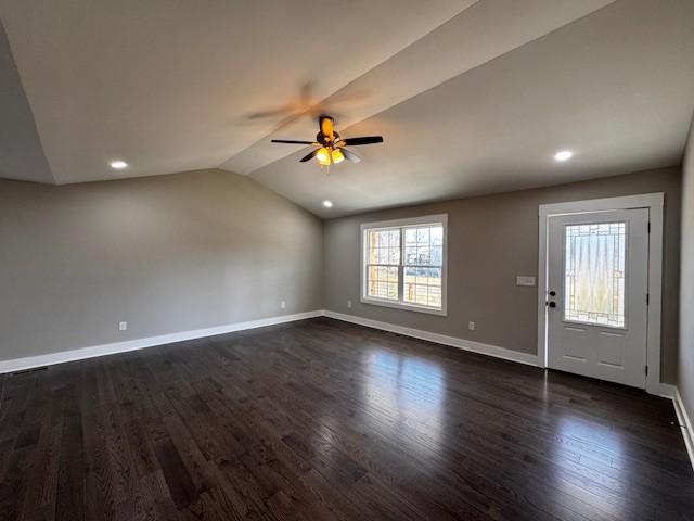 interior space with dark wood-style floors, baseboards, recessed lighting, ceiling fan, and vaulted ceiling