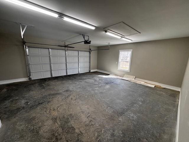 garage featuring a garage door opener and baseboards