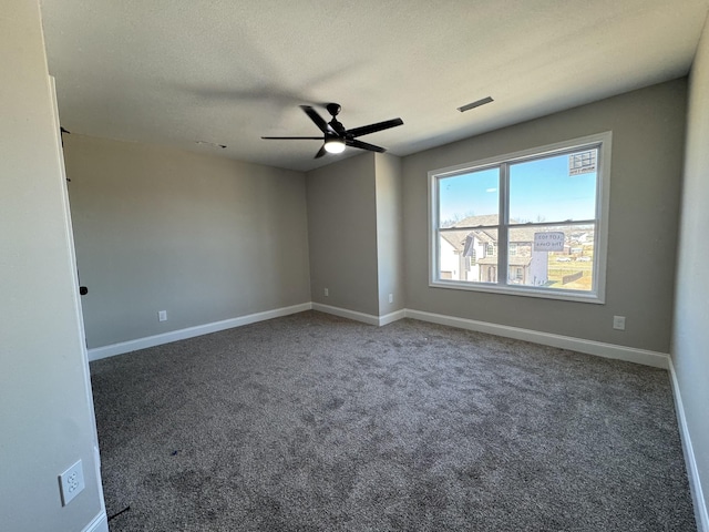 carpeted spare room with visible vents, baseboards, a textured ceiling, and ceiling fan