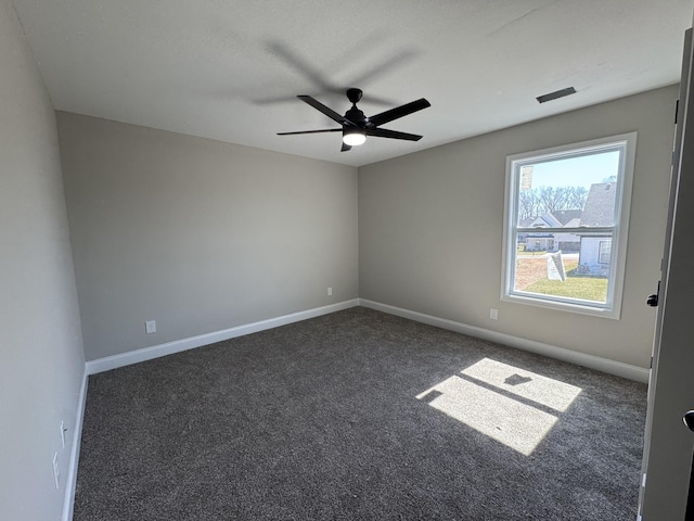 spare room featuring ceiling fan, baseboards, and carpet floors