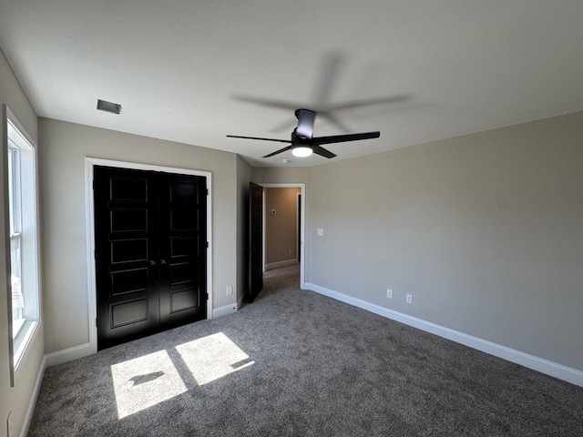 unfurnished bedroom featuring baseboards, carpet floors, and a ceiling fan