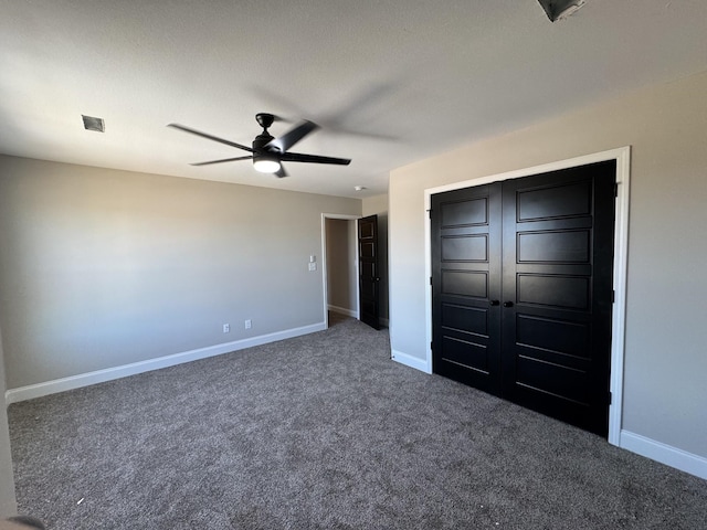 unfurnished bedroom with baseboards, carpet floors, a closet, and ceiling fan