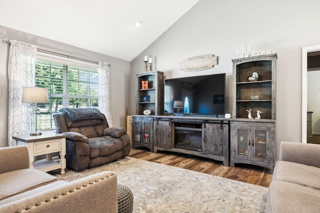 living area featuring lofted ceiling and wood finished floors