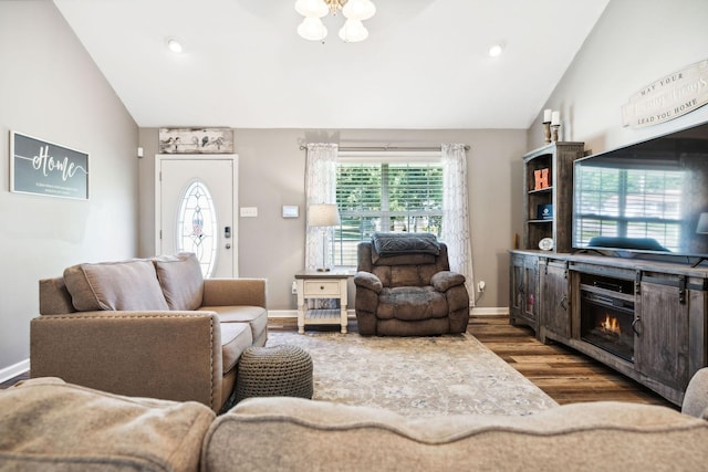 living room with vaulted ceiling, wood finished floors, and baseboards