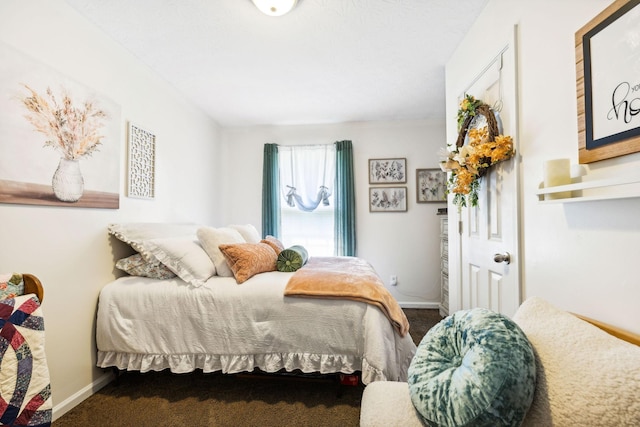 bedroom with baseboards and carpet floors