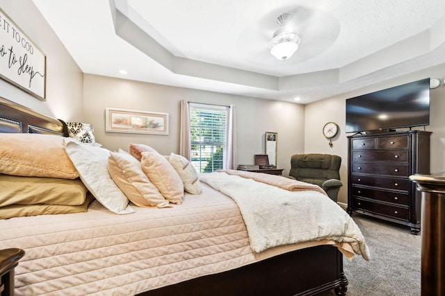 bedroom featuring recessed lighting, a tray ceiling, and carpet floors