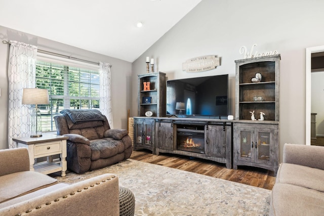 living room with wood finished floors and vaulted ceiling