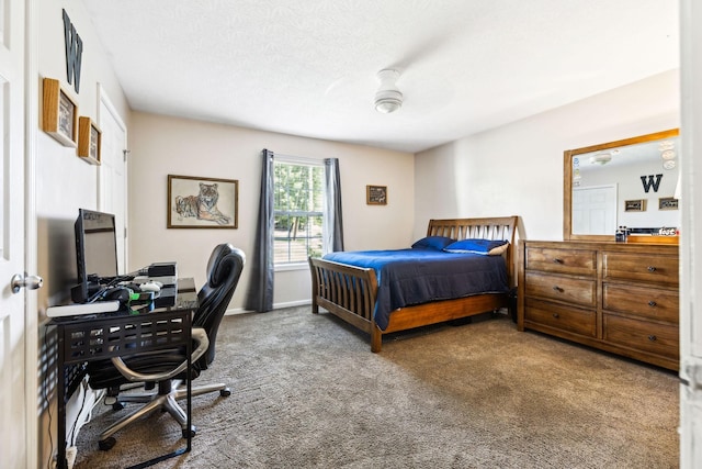 carpeted bedroom with a textured ceiling, baseboards, and ceiling fan