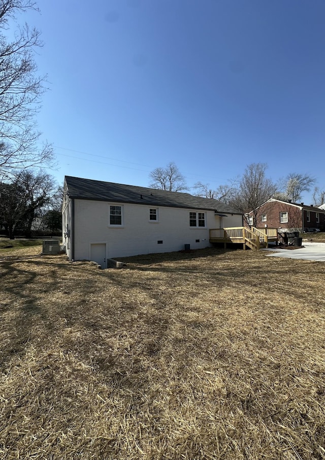 rear view of property with a wooden deck