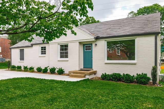 1613 Tammany Dr Unit A, Nashville, TN 37206 - view of front of home with brick siding, a shingled roof, and a front yard
