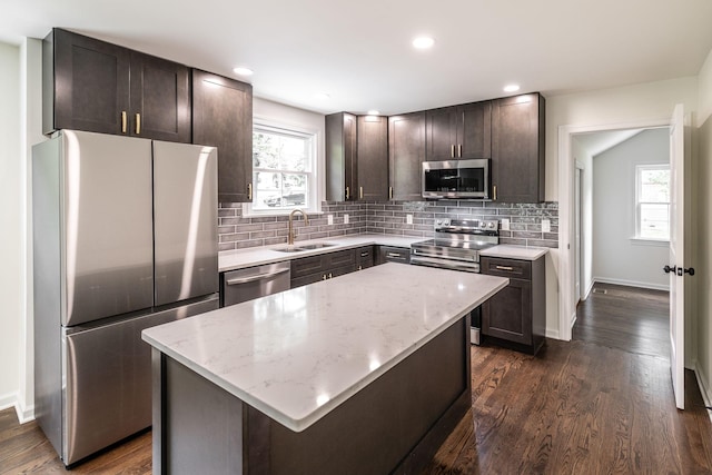 1613 Tammany Dr Unit A, Nashville, TN 37206 - kitchen featuring appliances with stainless steel finishes, a sink, dark brown cabinets, light stone countertops, and decorative backsplash