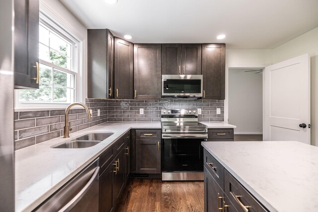 1613 Tammany Dr Unit A, Nashville, TN 37206 - kitchen featuring appliances with stainless steel finishes, a sink, light stone counters, recessed lighting, and backsplash