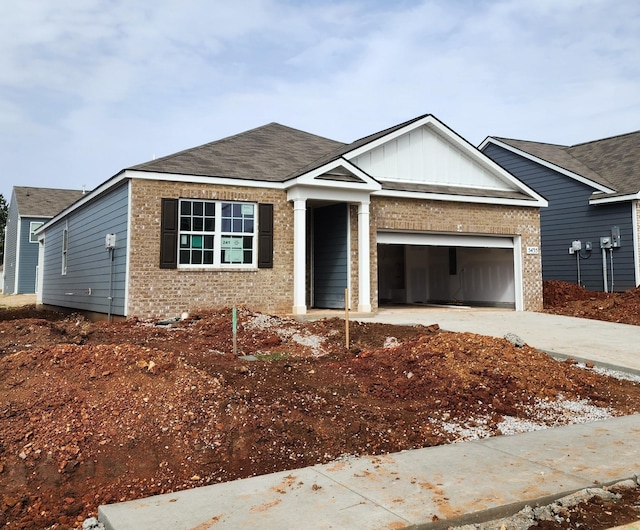 single story home featuring board and batten siding, an attached garage, brick siding, and driveway