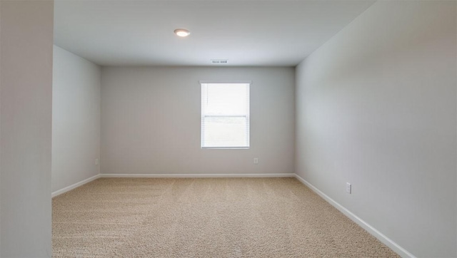 spare room with visible vents, baseboards, and carpet floors