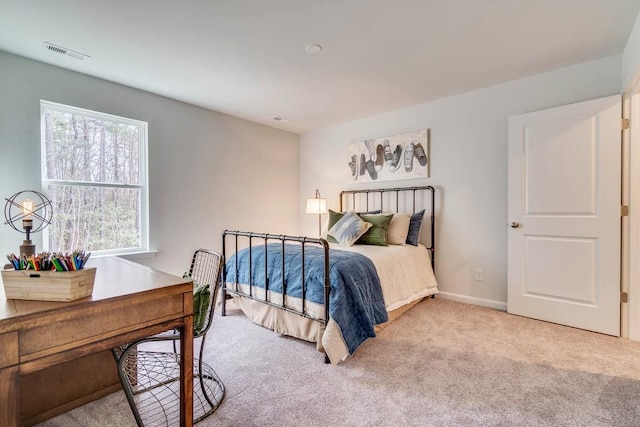 carpeted bedroom with visible vents and baseboards