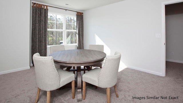 carpeted dining space with visible vents and baseboards